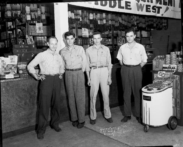 Winnegago Auto Replacement Parts Company, 103 North Park Street, four salemen in store in front of a display of auto parts.