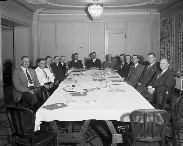 American Federation of State, County & Municipal Employees executive board. Thirteen men are sitting around a table.