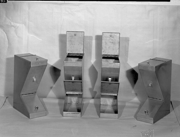 Display of four metal spice containers manufactured by Paul Krueger  & Company, 106 North Frances Street.