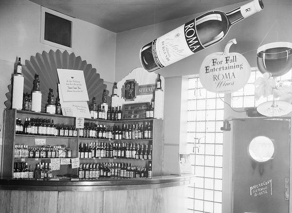 Roma Wine Display, interior at Licari Tavern, 767 West Washington Avenue, showing shelving with Roma sign.