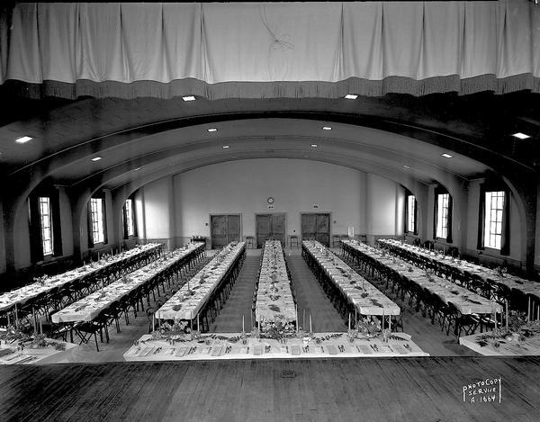 Turner Hall with tables set up for a banquet, 21 South Butler Street. View from stage toward front doors.