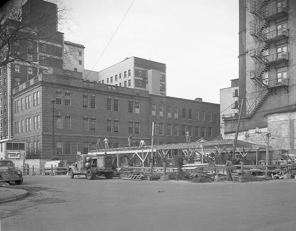 Wisconsin Telephone Co. building site, 122 West Main Street, from intersection of West Main Street and South Fairchild Street looking at first and second floors under construction. Also shows telephone building, 17 South Fairchild Street and back sides of Loraine Hotel, 123 West Washington Avenue and Park Hotel, 22 South Carroll Street. Building constructed by J.H. Findorff & Son Inc. construction company.