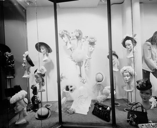 Carmen's, 9 South Pinckney, women's clothing store, featuring a display window of hats for the Carroll Hat Company.