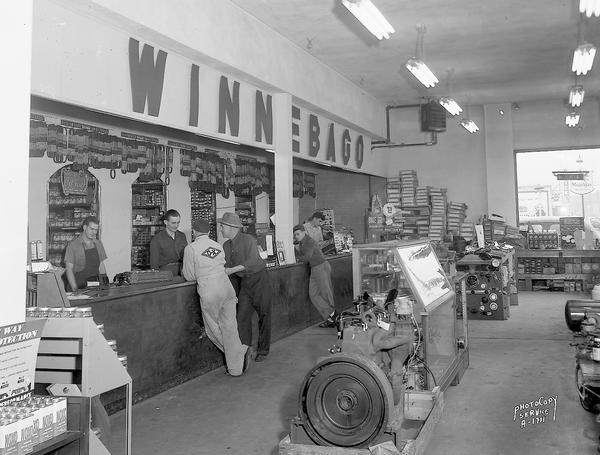 Winnebago Auto Replacement Company, 103 North Park Street. Interior view showing south end of store with various auto supplies, and the counter with employees and customers.