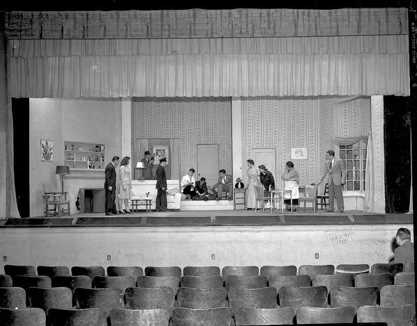 Madison Theatre Guild play on stage at West High School, 30 Ash Street, showing stage setting for "Mr. and Mrs. North," with eight actors and four actresses performing.