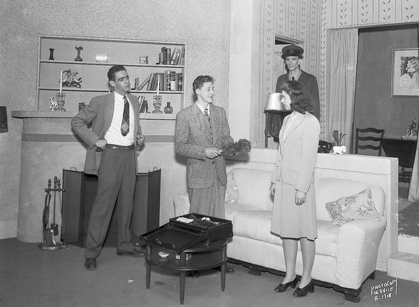 Madison Theatre Guild play on stage at West High School, 30 Ash Street. Close-up view of stage setting for "Mr. and Mrs. North," with one actress and three actors in costume. One actor is wearing a police costume and the others are in street clothes.
