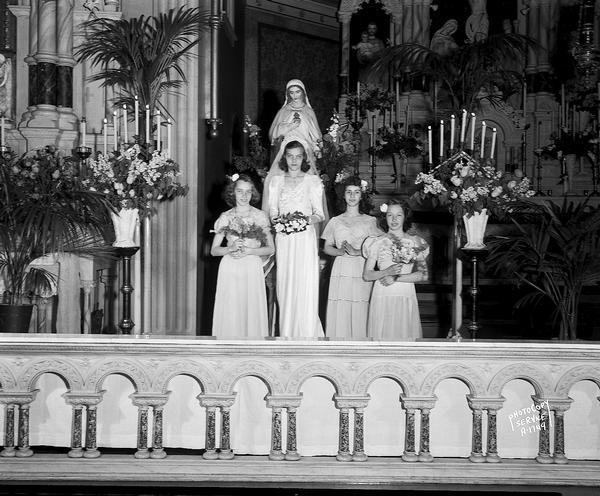 Interior of Holy Redeemer Catholic Church, 128 West Johnson Street, May Queen (Virgin Mary) crowning ceremony. Shows the coronation Queen accompanied by three attendants.