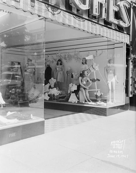 Hughes Ladies Wear store front, 20 East Mifflin Street, showing entry-way and display window with mannequins wearing summer attire.  Includes rubber mat in entry-way. Taken for Indemnity Insurance Company of North America.