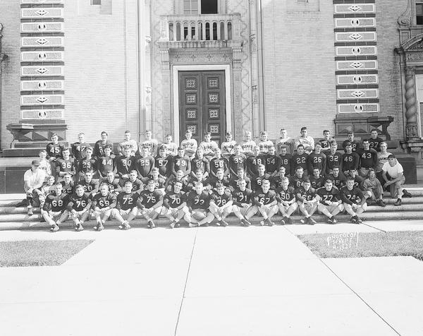 Group portrait of Edgewood High School football squad taken in front of the main entrance to the high school, at 1000 Edgewood Avenue.