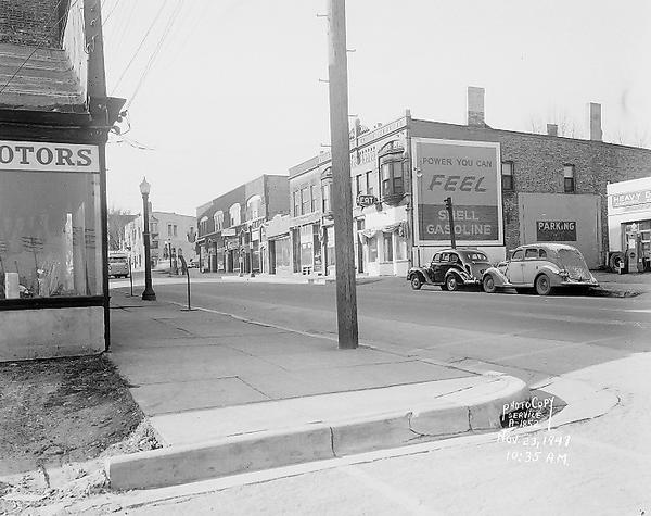 East Wilson Street at corner of South Hancock intersection looking toward West Wilson Street-King Street intersection taken to document site of Reynolds Bus accident scene.  Business seen at near corner is Electric Motor Service at 323 East Wilson Street. Business seen at far corner is Schroeder & Son Funeral Service, 235 King Street.  Businesses seen along north side of East Wilson Street include the Shell Service at 324 East Wilson Street, Young's Cafe at 316 East Wilson Street, Madison Watch Shop at 314 East Wilson Street, Volunteers of America at 310-12 East Wilson Street, Fred Kessenich (United Autographic Register Company) at 308 East Wilson Street, Johnson Maytag Company at 306 East Wilson Street, Meyer Printing at 304 East Wilson Street, and Stop Lite Tavern, 302 East Wilson Street.