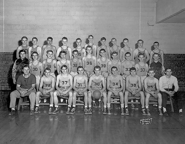 Group portrait of Edgewood High School boys basketball team, with two coaches and two student managers. New uniforms.