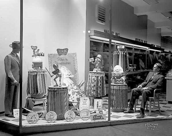 Display window at Speth's Clothing Store, 222 State Street, featuring Wembley ties and Alice in Wonderland characters.