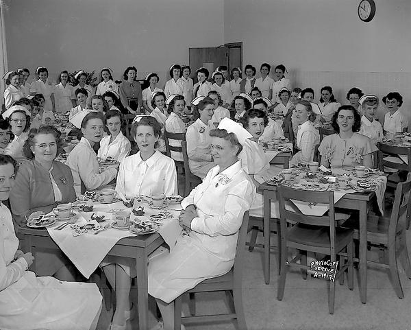 Group portrait of graduate nurses and other women attending a St. Patrick's Day luncheon at St. Mary's Hospital.