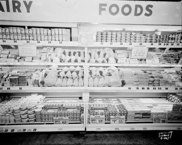 Front on view of poultry and egg display case, with dairy products on either side, at A & P grocery store, 623 University Avenue.