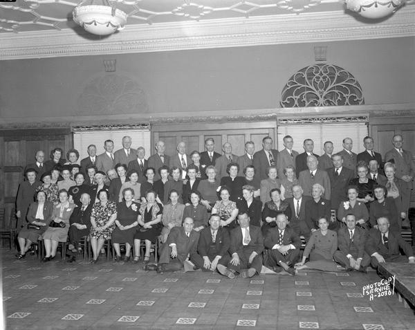 Group portrait of Wisconsin Telephone Company employees taken at the Blue Room, Park Hotel, 22 South Carroll Street.