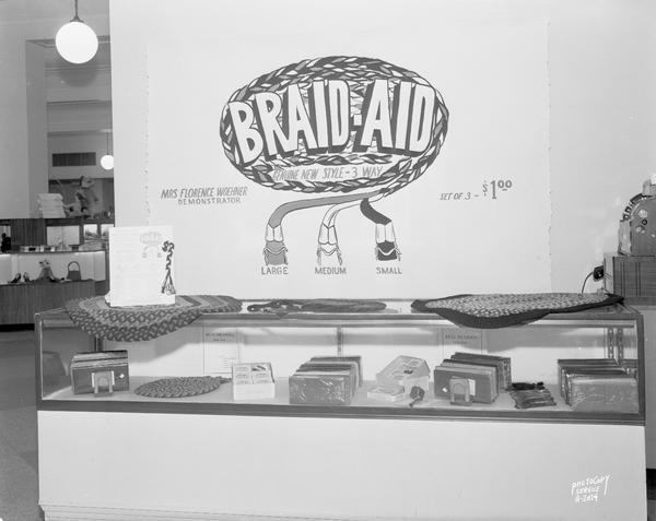 Manchester's "Braid Aid" rug braiding demonstration counter display.