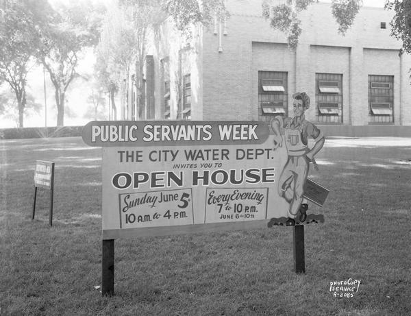 Public Servants Week sign "The City Water Dept. invites you to open house" on the lawn in front of main water pumping station, 311 North Hancock at East Gorham Street.