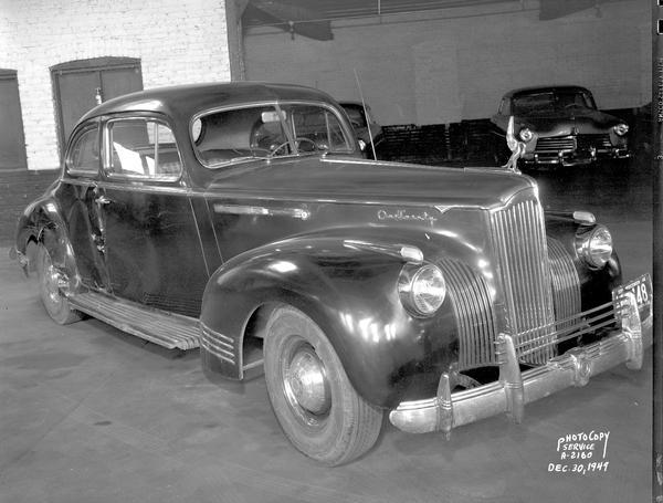 Front view of damaged Packard automobile at Stafford-Hudson Motors, 323-25 West Johnson Street.