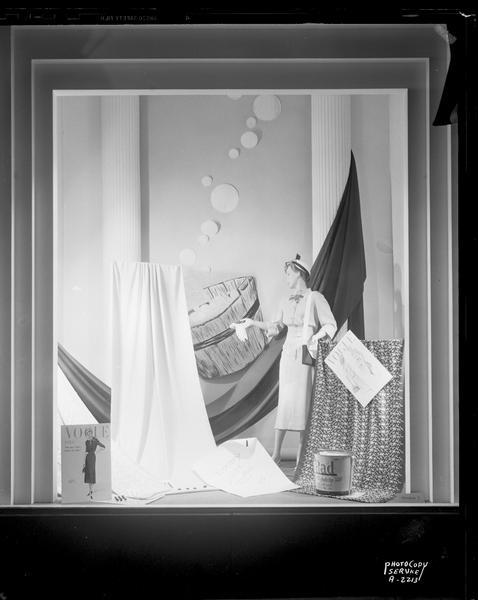 Manchester's, Inc., 2 East Mifflin Street, fabric display with Vogue patterns, one mannequin, and draped fabrics, "Tipperary, a completely washable soap'n water fabric." Window #3.