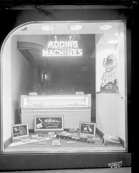Display window at Rowley & Schlimgen, 540 State Street, featuring Sheaffer's pen and pencil sets "for school days and career years" and a model trail layout, "With Sheaffer you are on the right track."