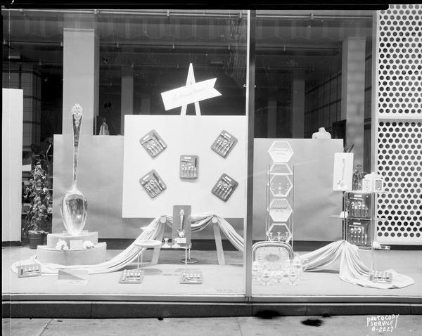 A window display at Manchester's, Inc., 2 East Mifflin Street, featuring International sterling silverware.
