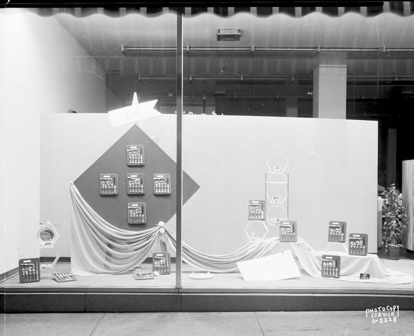 A window display at Manchester's, Inc., 2 East Mifflin Street, featuring Lunt sterling silverware.