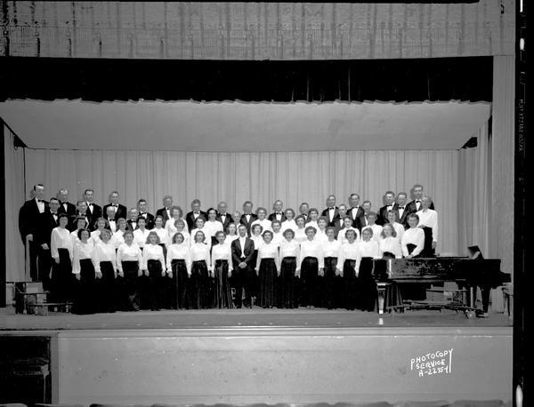 Group portrait of Philharmonic Chorus on stage at West High School.