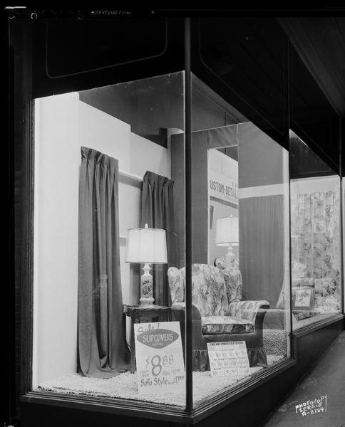Show window at Hill's Store, 202 State Street, featuring a display of Flextex two-way-stretch slipcovers.