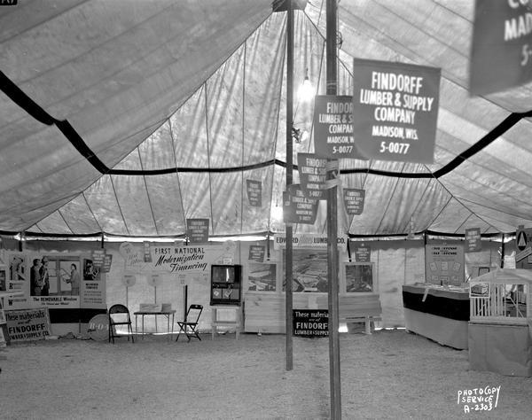 Parade of Homes displays tent featuring Findorff Lumber & Supply Company, First National modernization financing, Edward Hines Lumber Co. and a civil defense display.