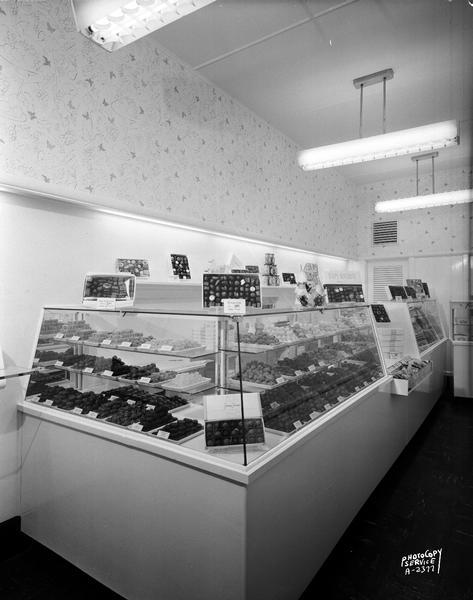 Interior view of Fanny Farmer Candy Store, 10 South Carroll Street, including a candy display counter.