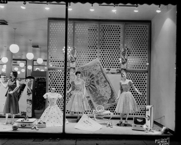Manchester's, 2 East Mifflin Street, display window "A" featuring women's dresses and shoes, for "cruise attire," on three mannequins.
