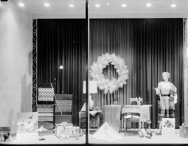 H.S. Manchester's, Incorporated, 2 East Mifflin Street, show window display of Singer Sewing Machines, fabrics, mannequin, and Christmas wreath.