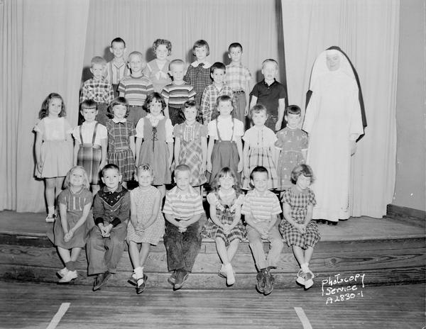 Group portrait of St. Patrick's Catholic Church grade school, 410 East Main Street, first grade class with Sister Marie Edward, O.P.