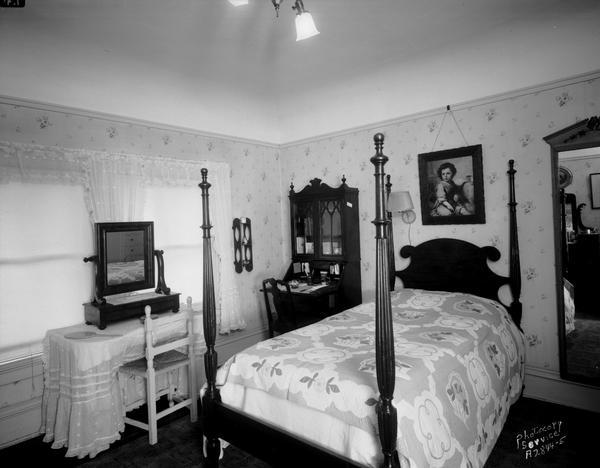 Bedroom of Sybil A. Hanks in Lucian M. Hanks house, 525 Wisconsin Avenue, with a quilt on the bed.