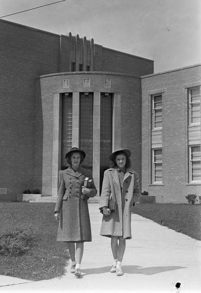 Two women standing outside of Di Ricci Hall at Edgewood College.