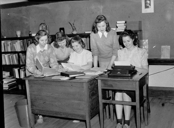 Five girls at desk at Edgewood College.