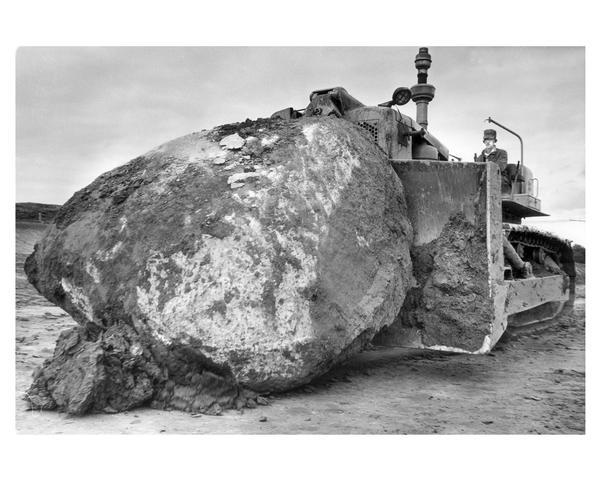 Moving a very large boulder with a bulldozer during construction of  Highway 94 in Waukesha County.