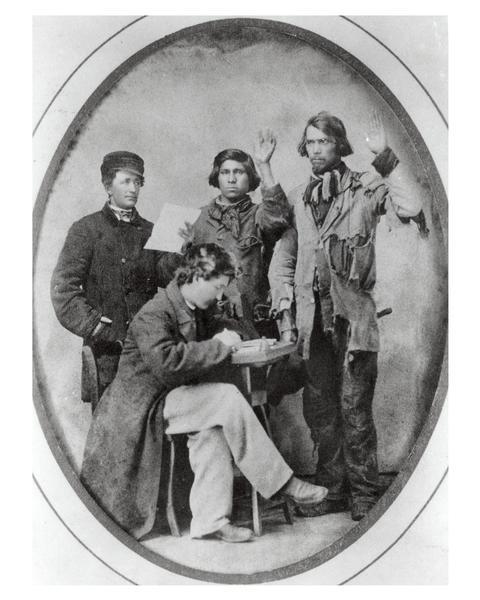 Thomas Bigford (in cap, on left) and another official swearing-in two Native American Civil War recruits. Thomas Bigford (1815-1890) of Taycheedah, Wisconsin, was a farmer who served as a local recruiting officer during the war. According to Bigford, the recruit on right may be Adam Scherf of Stockbridge, who was said to have served in the same regiment with Thomas Bigford's son Royal. Royal Bigford was a private in the 1st Battery, Light Artillery, but Scherf is not listed.