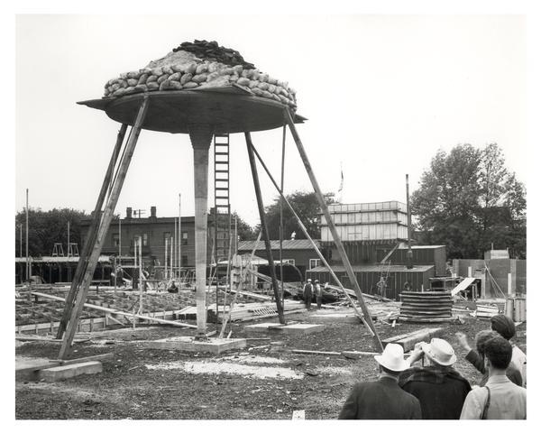 Frank Lloyd Wright, monitoring the construction and testing of load-bearing pylons for the Johnson Wax Building.