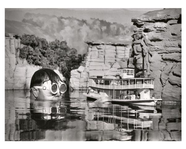 Miniature model of the Wisconsin Dells. Goggled diver, Ollie Reese, swimming with Dells recreation boat. This completely landscaped exhibit was built to scale, 1/4 inch to a foot, faithfully depicting the Wisconsin Dells recreation area.