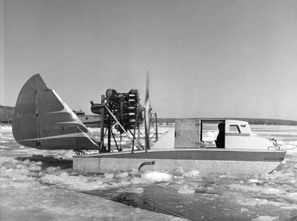 This was the first boat & sled-type wind sled built on Madeline Island. Built by Elmer Nelson for Howard Russell between 1950-1951. Had a 9-cylinder R-680-E3 Lycoming engine. The tail was a portion of a Stinson AT-19 airplane. Overall length of the wind sled was 23'6" and 7'10" wide with a carrying capacity of 6-7 persons. This wind sled was operated between Bayfield and Madeline Island from 1951-1957.