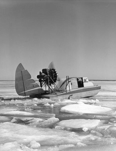 This was the first boat & sled-type windsled built on Madeline Island. Built by Elmer Nelson for Howard Russell between 1950-1951. Had a 9-cylinder R-680-E3 Lycoming engine. The tail was a portion of a Stinson AT-19 airplane. Overall length of the windsled was 23'6" and 7'10" wide with a carrying capacity of 6-7 persons. This windsled was operated from 1951-1957 between Bayfield and Madeline Island.