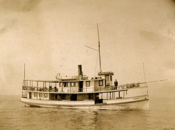 Captain F.A. Bishoff and engineer Dan Cook on board the ferry "Plowboy."