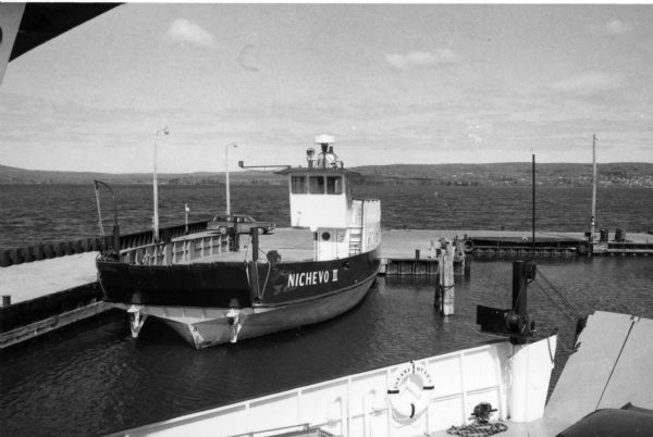 Steel-hulled ferry "Nichevo II" at the city dock in La Pointe. The "Nichevo II" began service in 1962. It was built by Fraser Shipyards of Superior for Harry Nelson. It is a drive-through ferry that carries ten cars and 150 passengers.