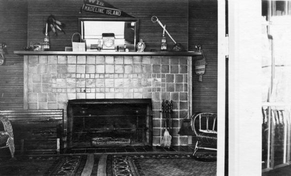 Tile fireplace inside the Hull cottage on Madeline Island. Display of Native American artifacts and other items are on the mantel. The Hull cottage, a.k.a. Coole Park Manor, was later known as Chateau Madeline.