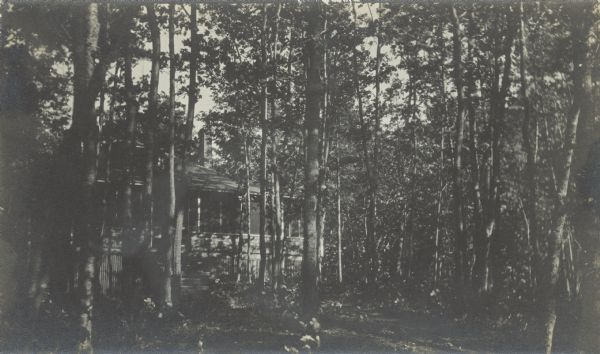View through trees of "Lar-Board" (Baker's Cottage), later Hamilton Rose Cottage.