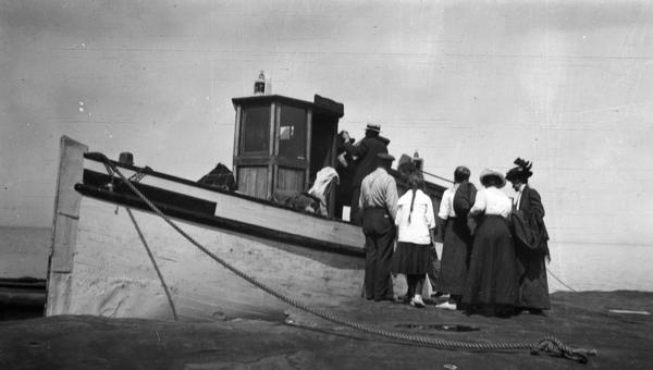 Hull family boarding the "Lizzie W." from one of the Apostle Islands.