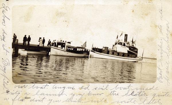 Boats and people at the Bayfield dock on Labor Day 1912. Boats include <i>Thelma</i>; <i>Lusitania</i>; which later became a U.S. Mail boat; Captain Angus' old sailboat made into a launch; and the steamboat <i>Skater</i>.