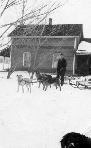 Howard Russell with dog team bringing the mail to La Pointe.