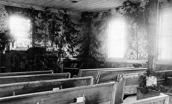 Interior of the Congregational Church, a.k.a. Old Mission Church. The interior walls are covered with cedar trees.